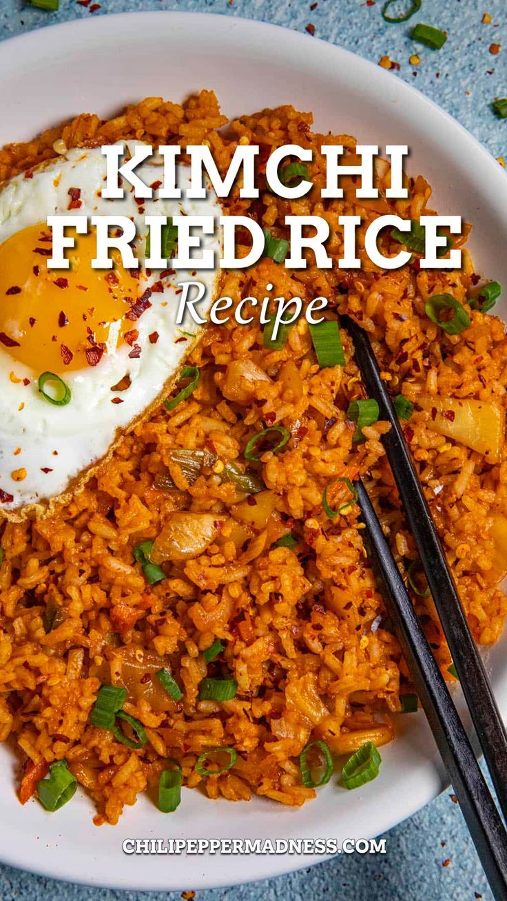 Kimchi Fried Rice in a big white bowl with chopsticks on top. Meals With Kimchi Rice Bowls, Kimchi Fried Rice With Pork Belly, What Do You Eat Kimchi With, Fried Kimchi Rice, Easy Kimchi Fried Rice Recipe, Kim Chee Fried Rice, Kimchee Fried Rice Korean Style, Kim Chee Fried Rice Hawaii, Chicken Kimchi Fried Rice