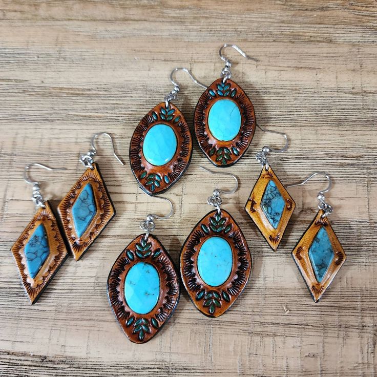 six pieces of jewelry sitting on top of a wooden table