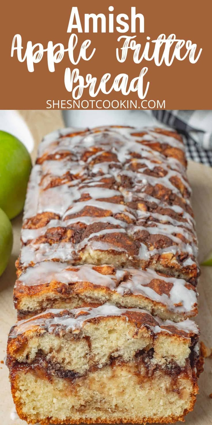 a loaf of apple bread with icing on top and green apples in the background