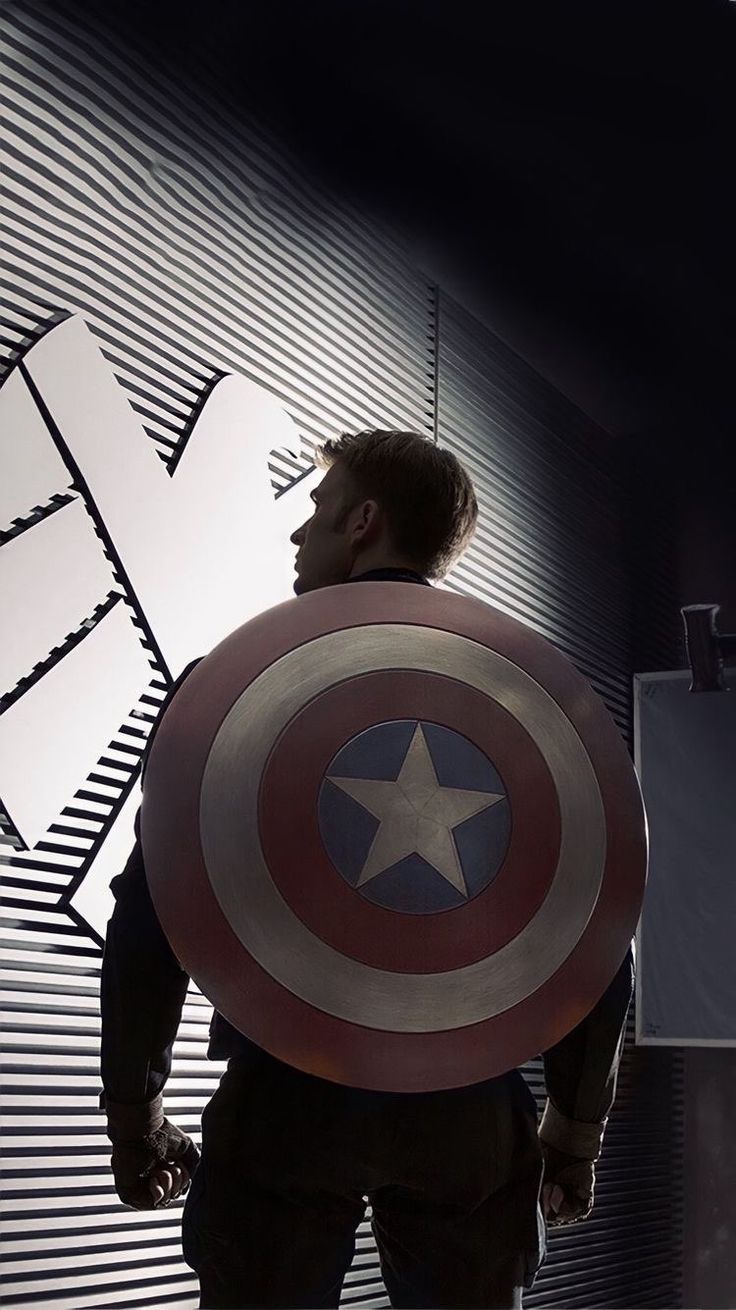 a man in a captain america costume holding a shield