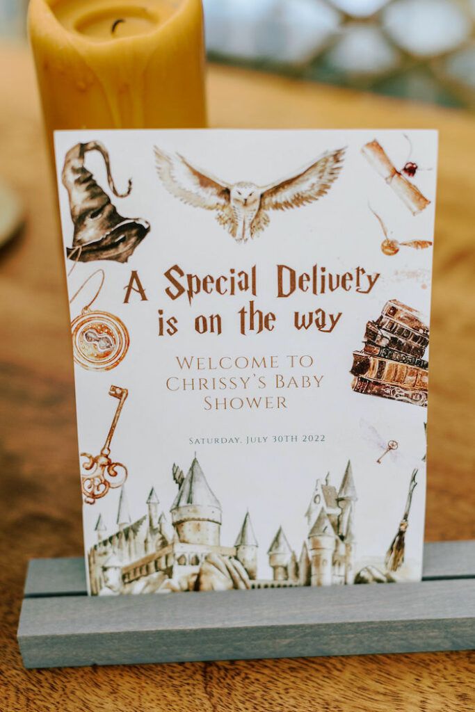 a special delivery is on the way card sitting next to a candle holder with an image of hogwart's castle