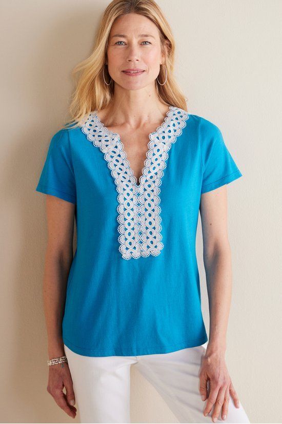 Introducing a t-shirt that's anything but basic. Geometric lace trim brings high-contrast detail to this short-sleeve style, framing the split V-neckline and front bib. Spring Cotton Tops With Contrast Lace, Casual Tops With Contrast Lace For Spring, Spring Top With Crochet Trim And Short Sleeves, Spring Tops With Crochet Trim And Short Sleeves, Short Sleeve Tops With Crochet Trim For Spring, Cotton Top With Contrast Lace For Summer, Cotton Tops With Lace Trim And Short Sleeves, Casual Stretch Top With Lace Collar, Casual Stretch Tops With Lace Collar