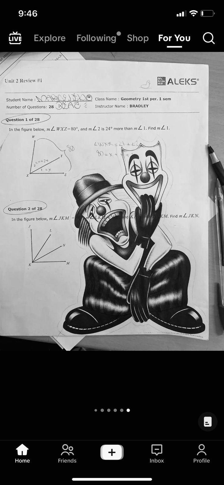 a black and white photo of a cartoon character on a piece of paper next to a pen