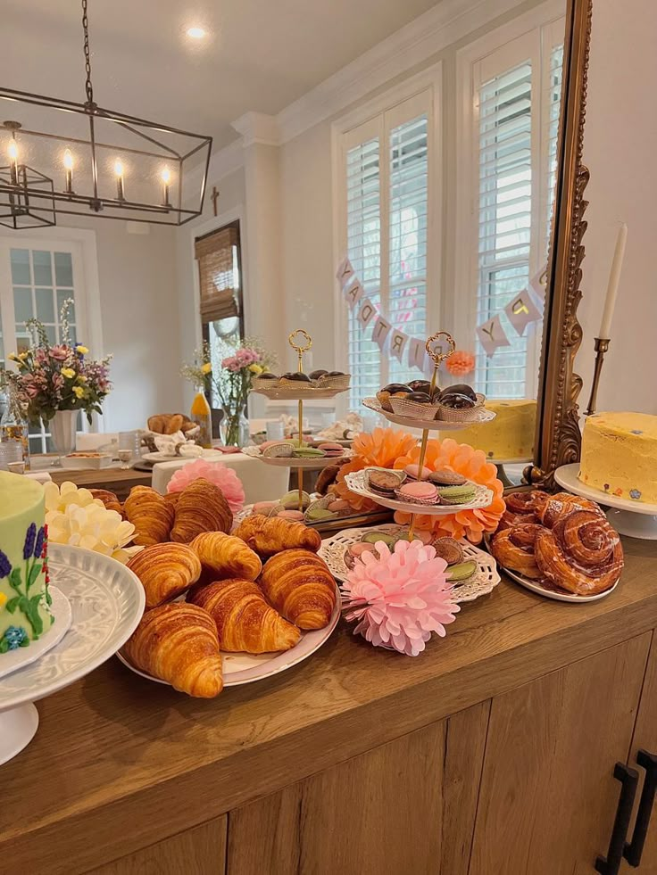 an assortment of pastries and desserts on a buffet table