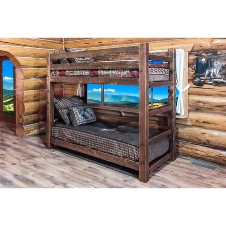 a bunk bed sitting inside of a wooden cabin