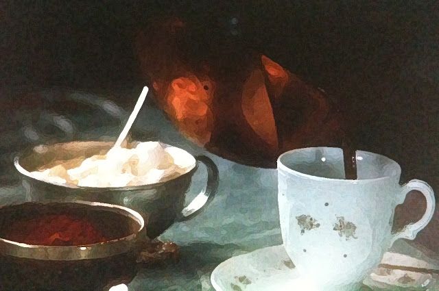 two cups and saucers sitting on a table with food in bowls next to them