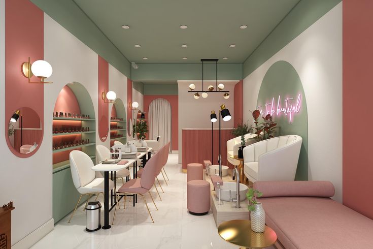 the interior of a nail salon with pink and green walls, white furniture and gold accents