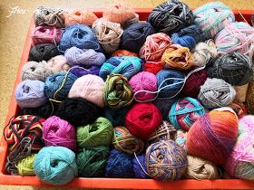 balls of yarn are sitting in a basket on the floor and ready to be used