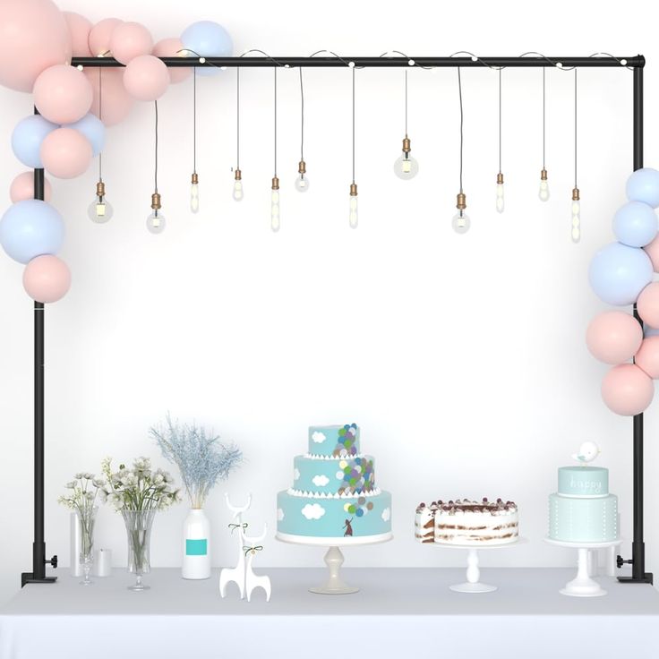 a table topped with a cake and lots of balloons hanging from it's ceiling