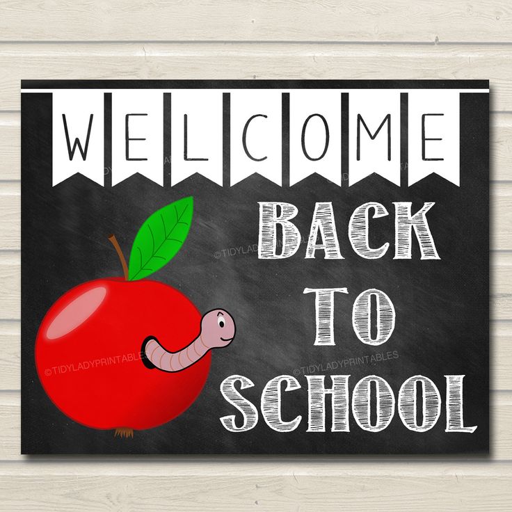 welcome back to school sign with an apple and worm on the front, blackboard background