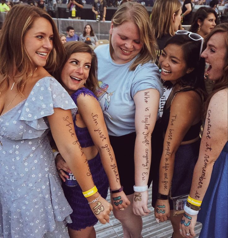 a group of young women standing next to each other with their arms wrapped around one another