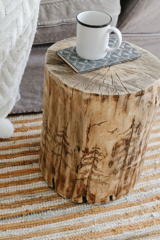 a wooden table with a coffee cup on it and a rug in front of it