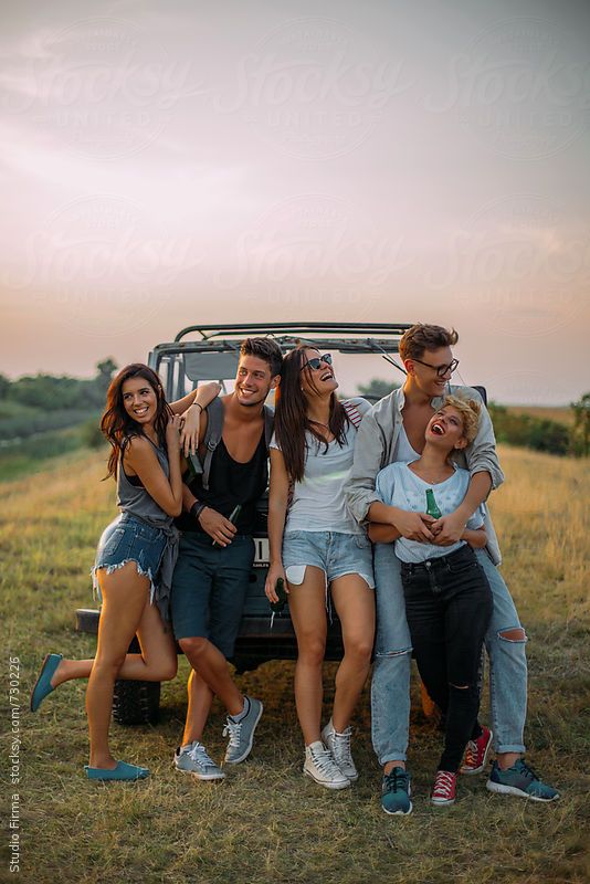 a group of young people posing in front of an old truck by luma studio for stocksy photography