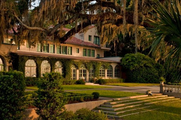 a large house with lots of windows and trees