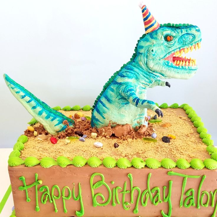 a birthday cake with a dinosaur on it