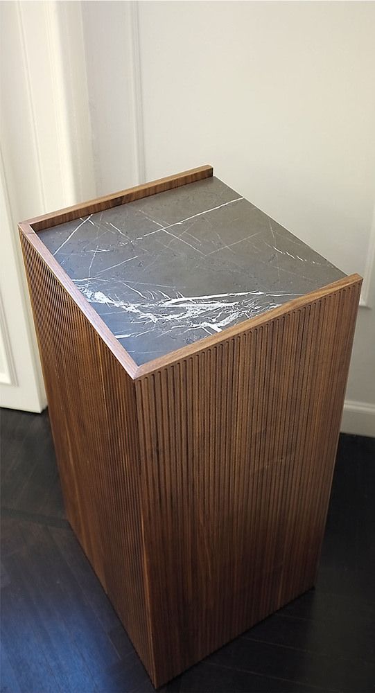 a wooden box sitting on top of a hard wood floor