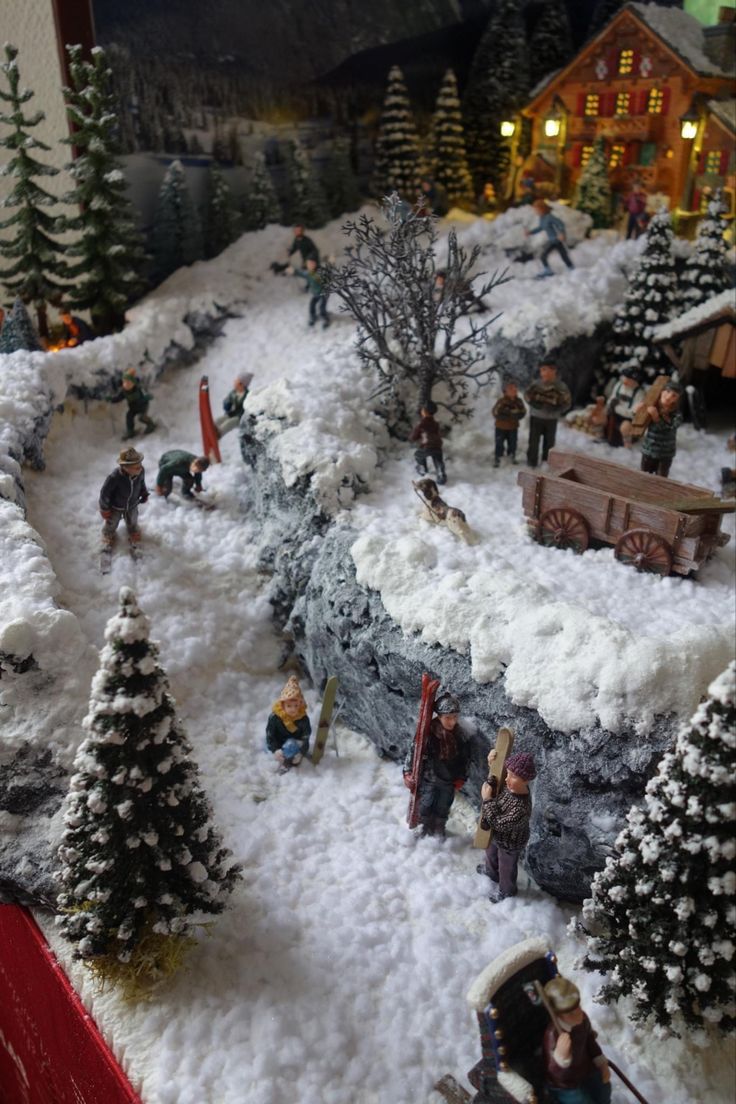 a christmas scene with people and trees in the snow