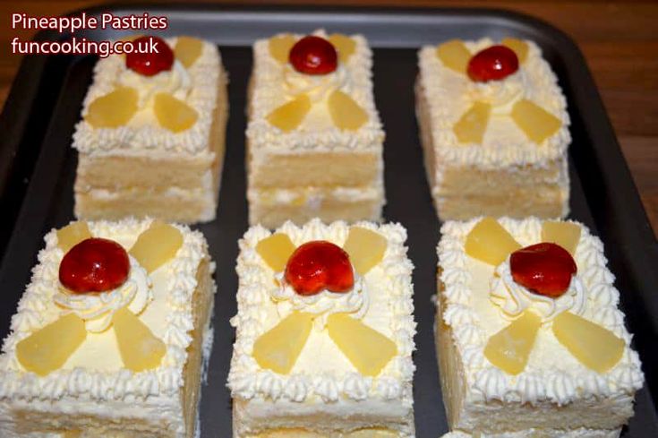 several pieces of cake with pineapples and cherries on top in a pan