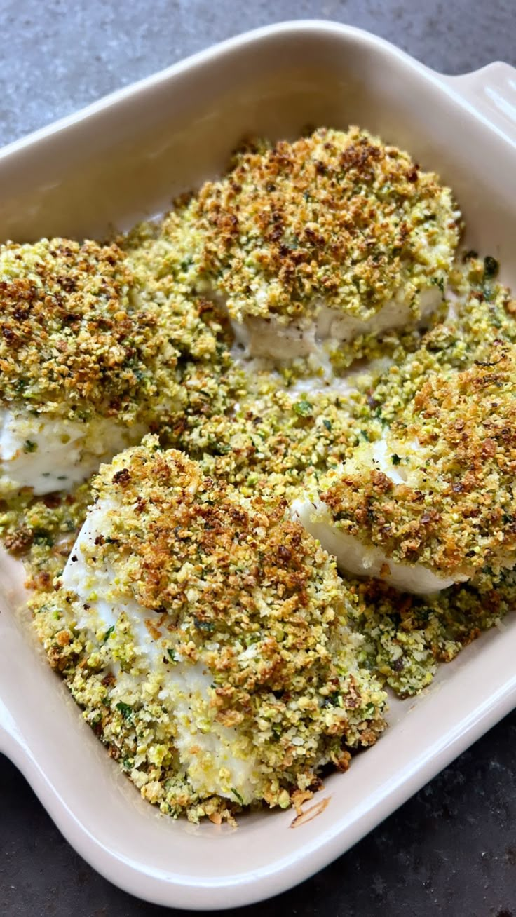 broccoli florets in a white dish with seasoning sprinkled on top