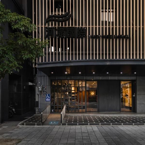 the entrance to an office building with wooden slats on the front and second story