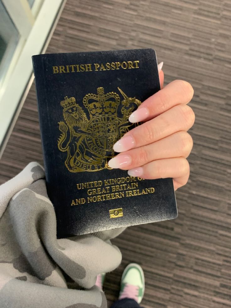 a person holding a british passport in their hand