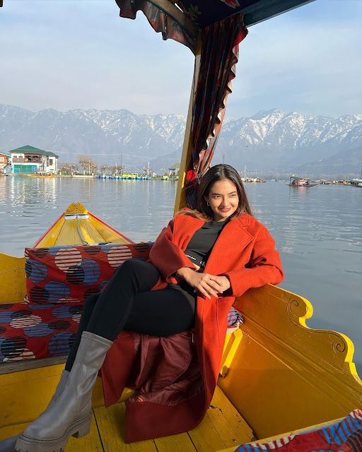 a woman sitting on the back of a yellow boat