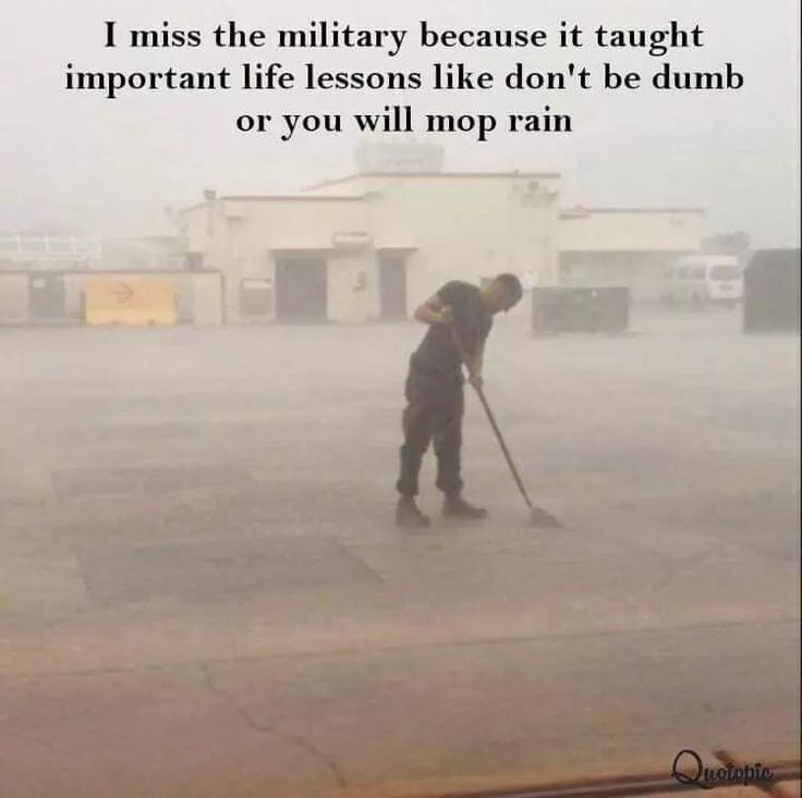 a man with a mop is standing in the rain