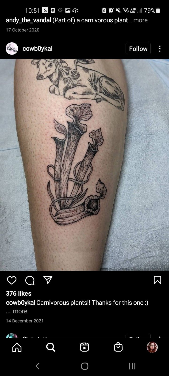 a person with a tattoo on their leg that has flowers and leaves growing out of it