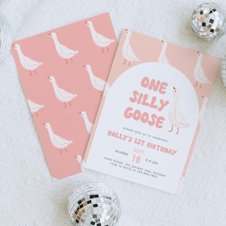 a pink and white birthday party with doves on the table next to disco balls