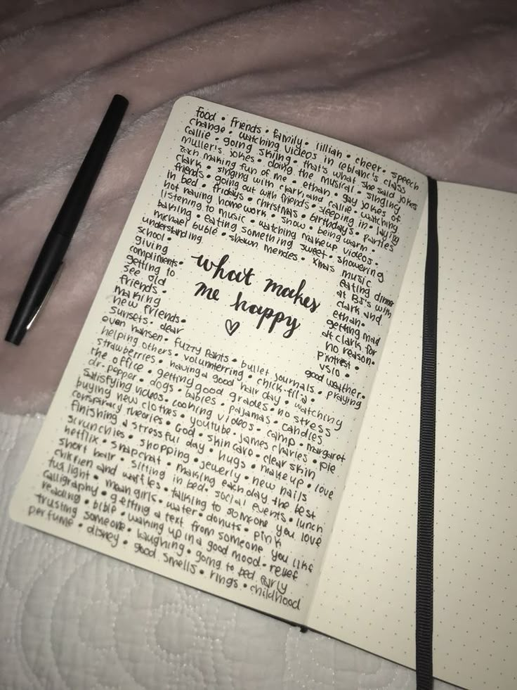 an open notebook with writing on it next to a pen