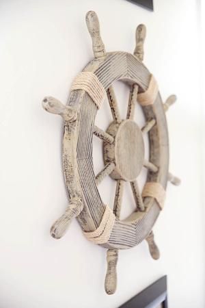 a wooden ship wheel hanging on the wall