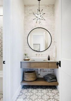 a bathroom with a sink, mirror and tiled floor