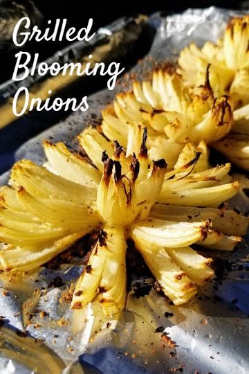 grilled blooming onions on tin foil with text overlay that reads grilled, blooming onions