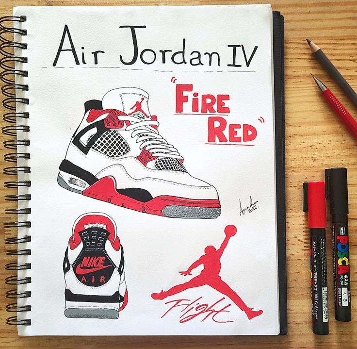 an air jordan iv fire red book next to markers and pens