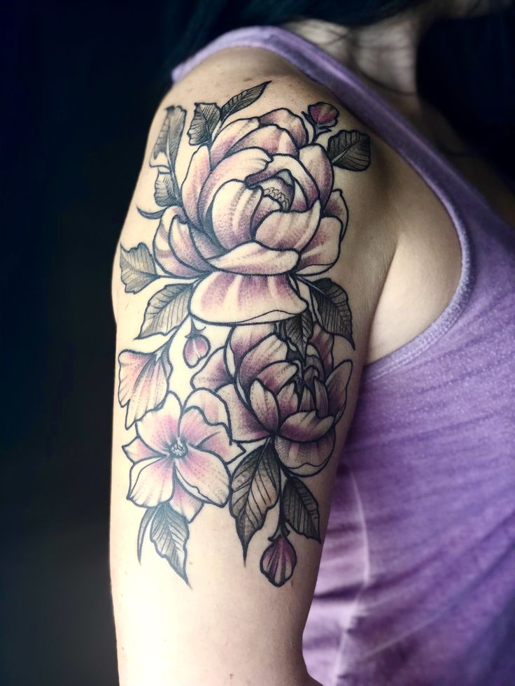 a woman's arm with a rose tattoo on the left side of her arm