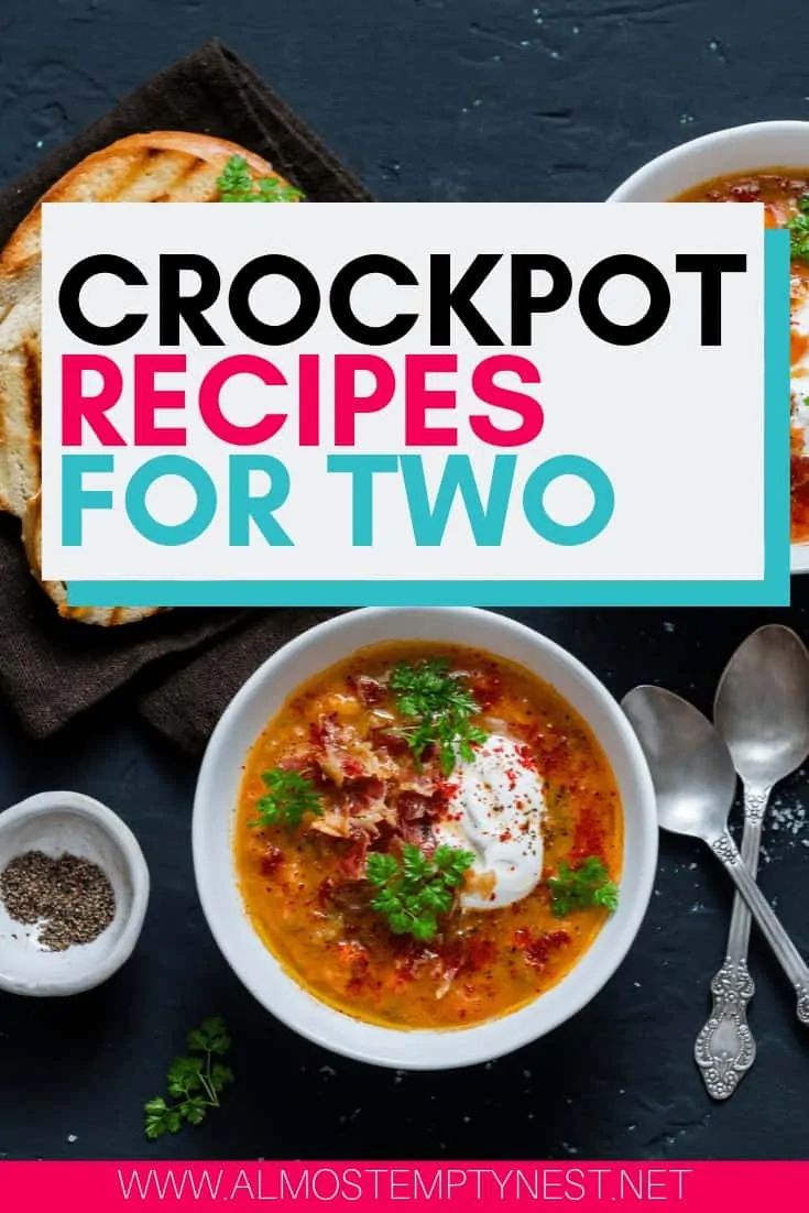 two bowls of crockpot soup with bread on the side and spoons next to it