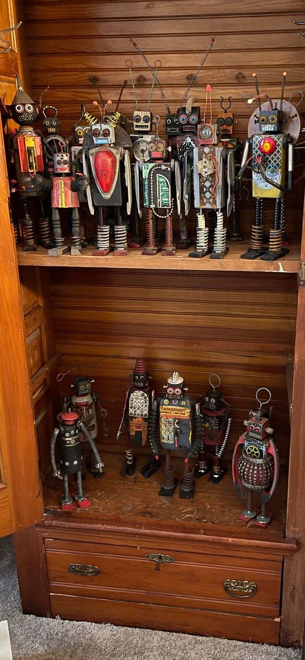 an old wooden book shelf filled with lots of figurines