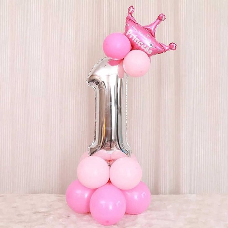 a pink number one balloon with a crown on top