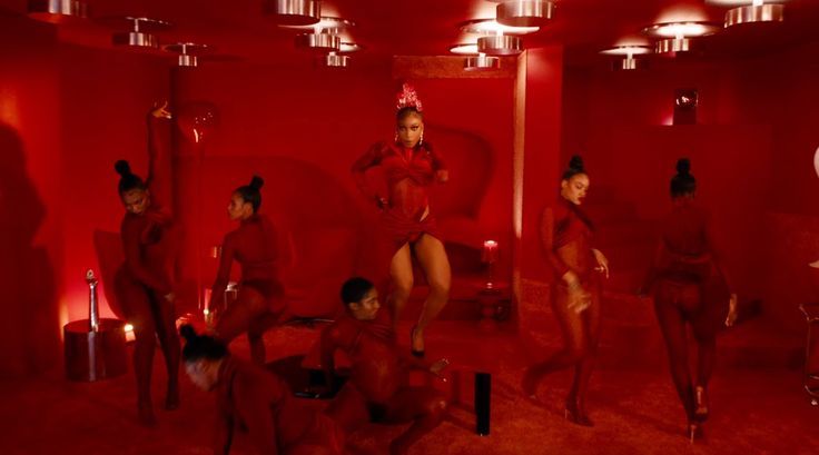 a group of women in red outfits posing for the camera