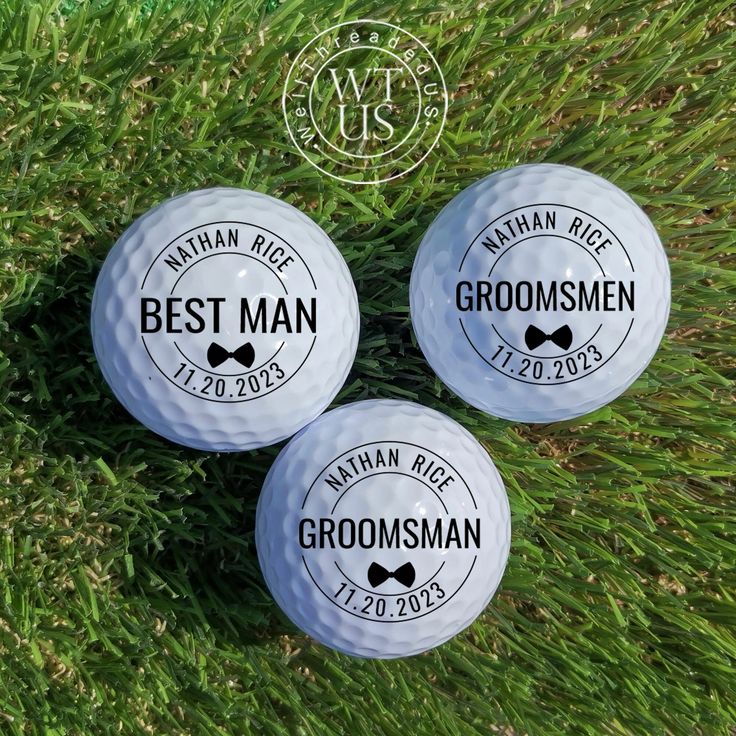 three groomsmen golf balls sitting on the grass with their names printed on them