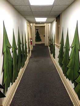 an office hallway decorated for christmas with trees painted on the walls and carpeted floor