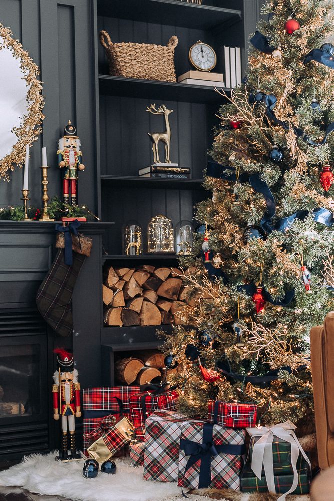 a decorated christmas tree in front of a fireplace