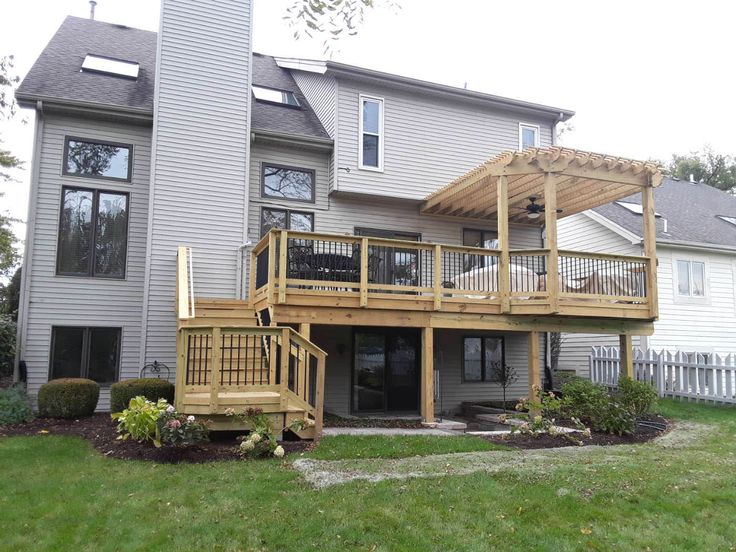 a large house with a deck in the front yard