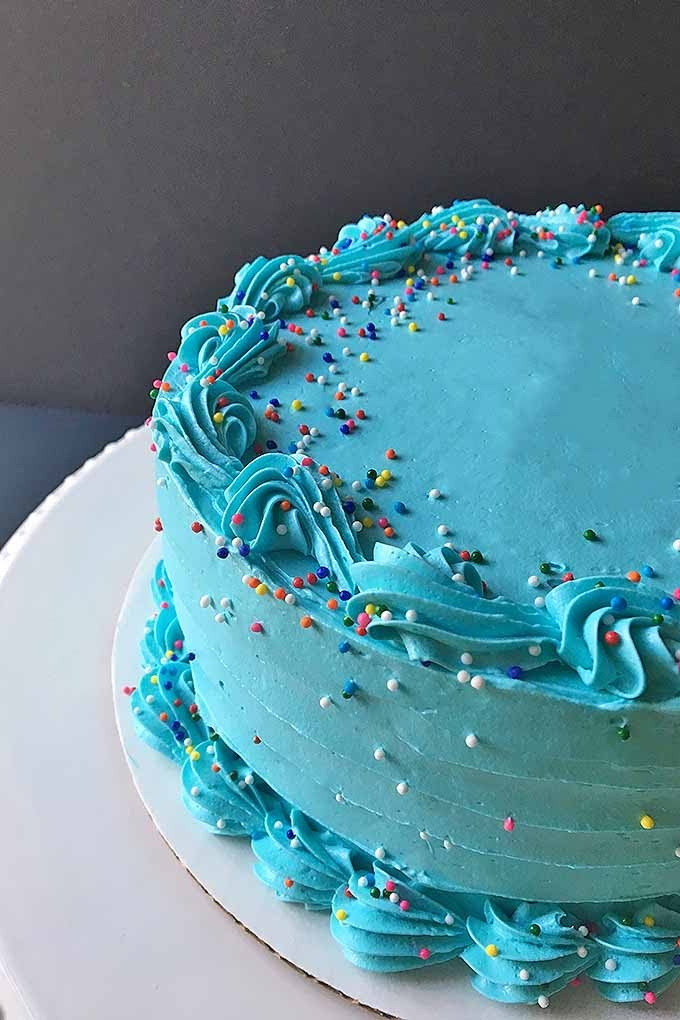 a blue frosted cake with sprinkles on it