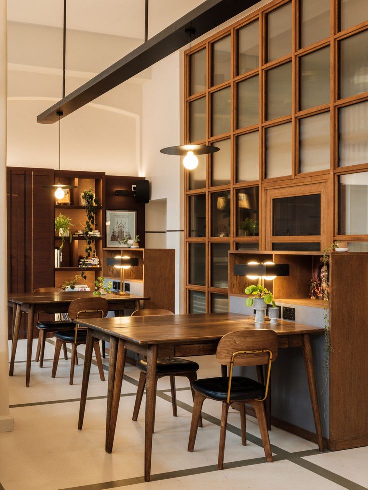 a dining room with wooden tables and chairs