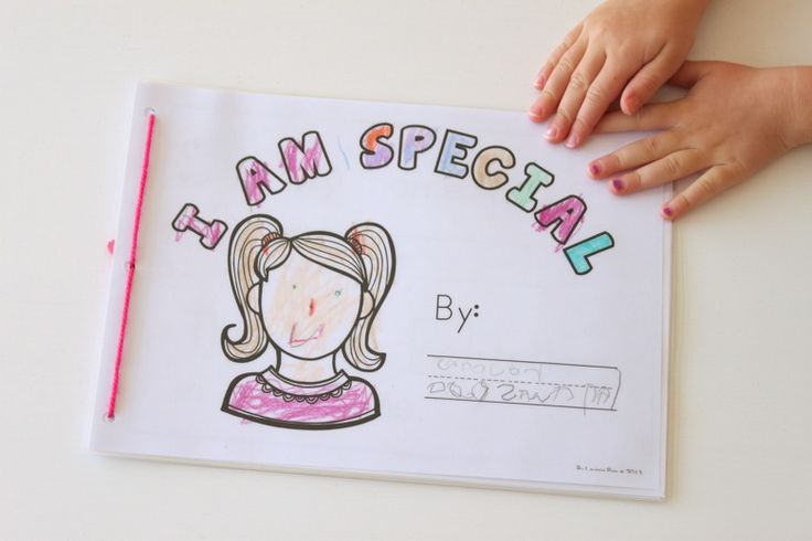 a child's hand on top of a paper with the words i am special