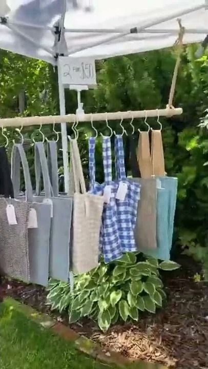 several bags hanging from a clothes line under a tent