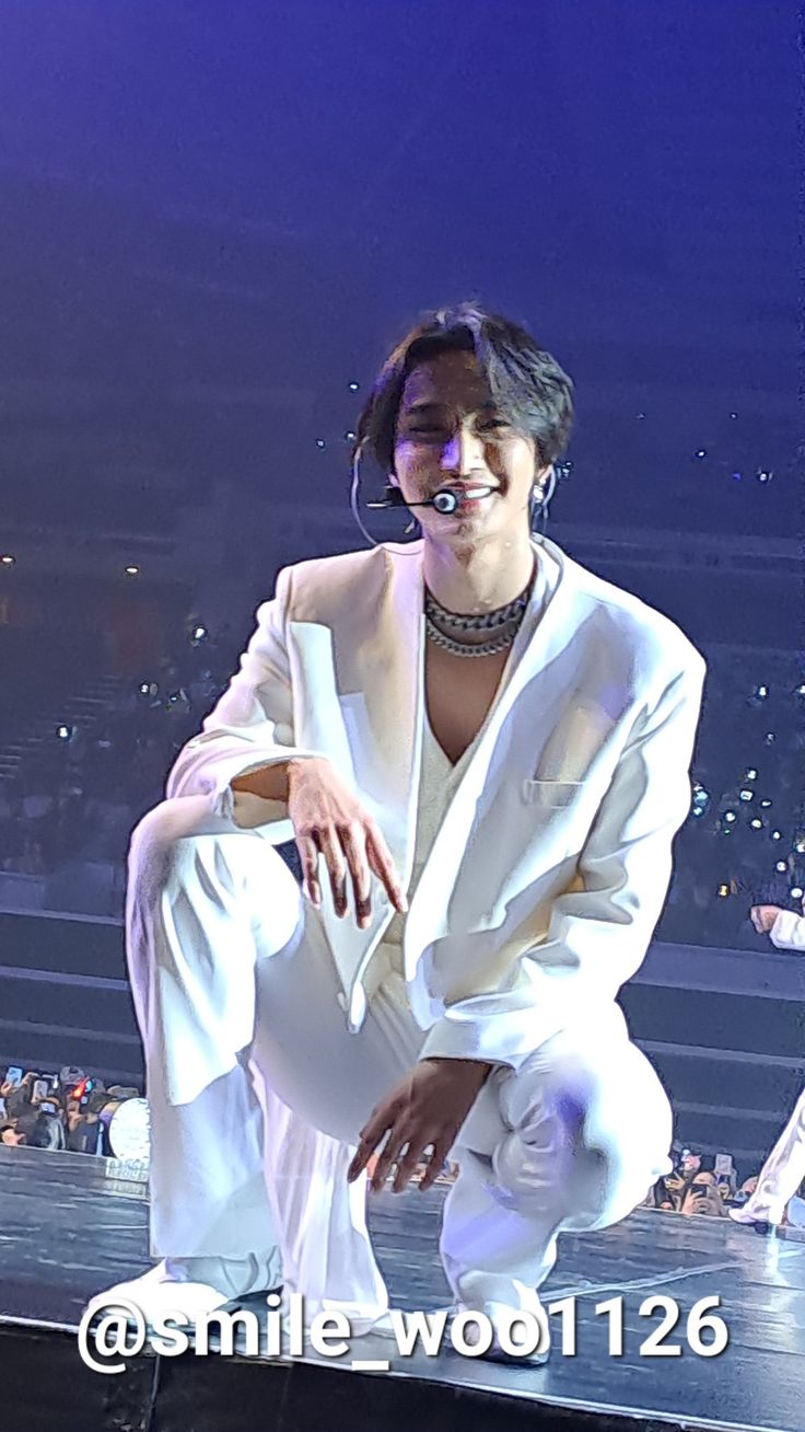 a woman sitting on top of a stage