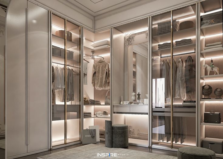 a walk in closet with mirrored doors and shelves filled with clothes, shoes and other items