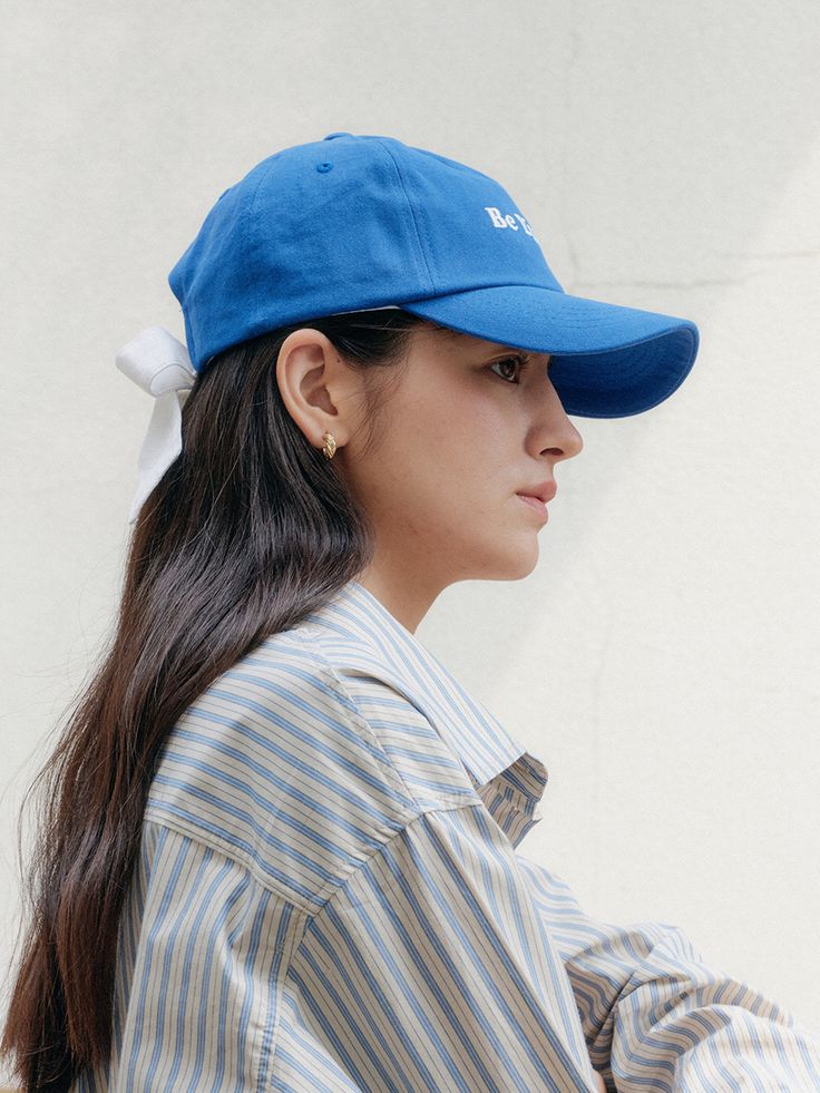 a woman wearing a blue hat and striped shirt